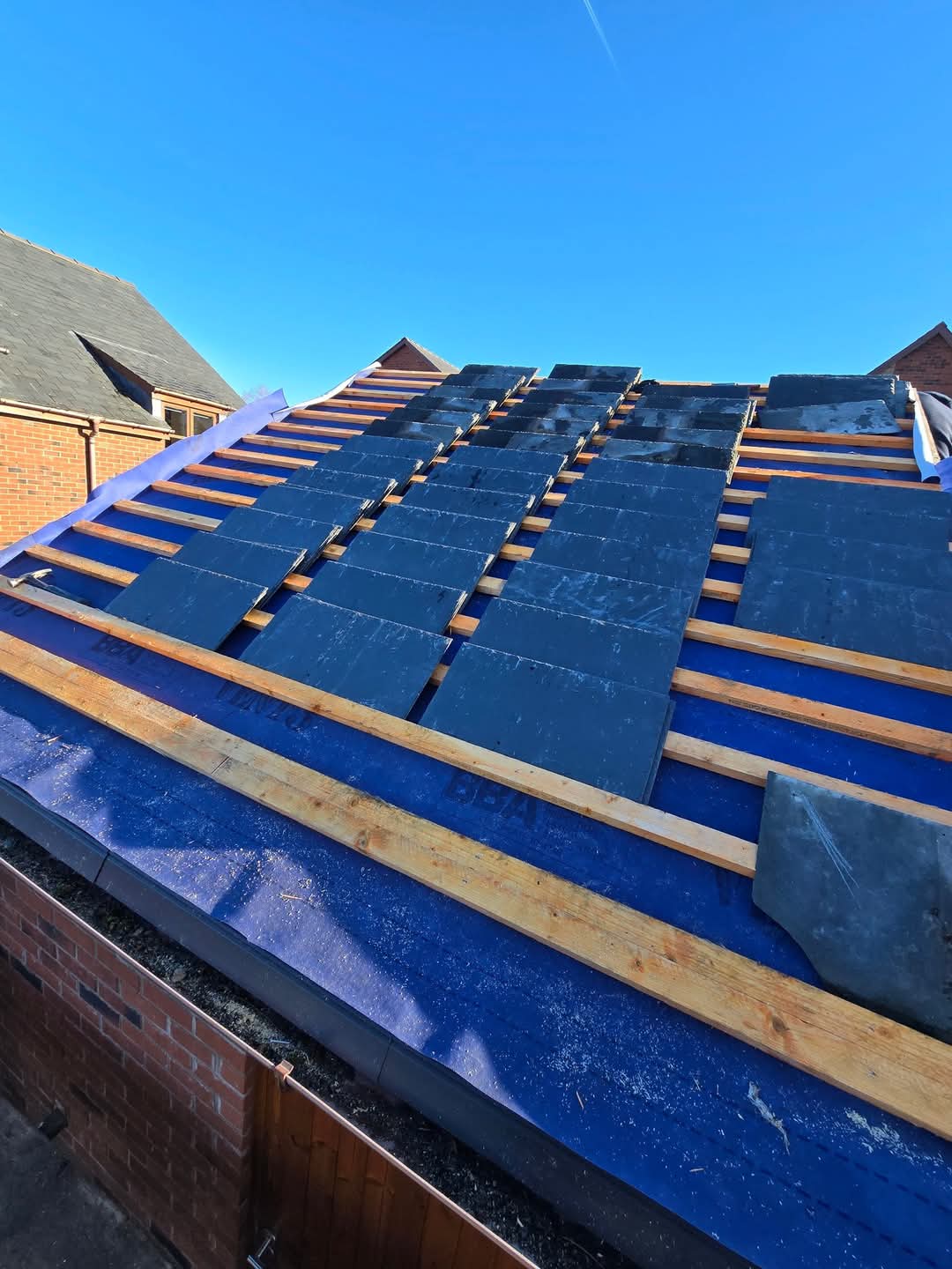 Reused slates dry-laid on fresh treated battens