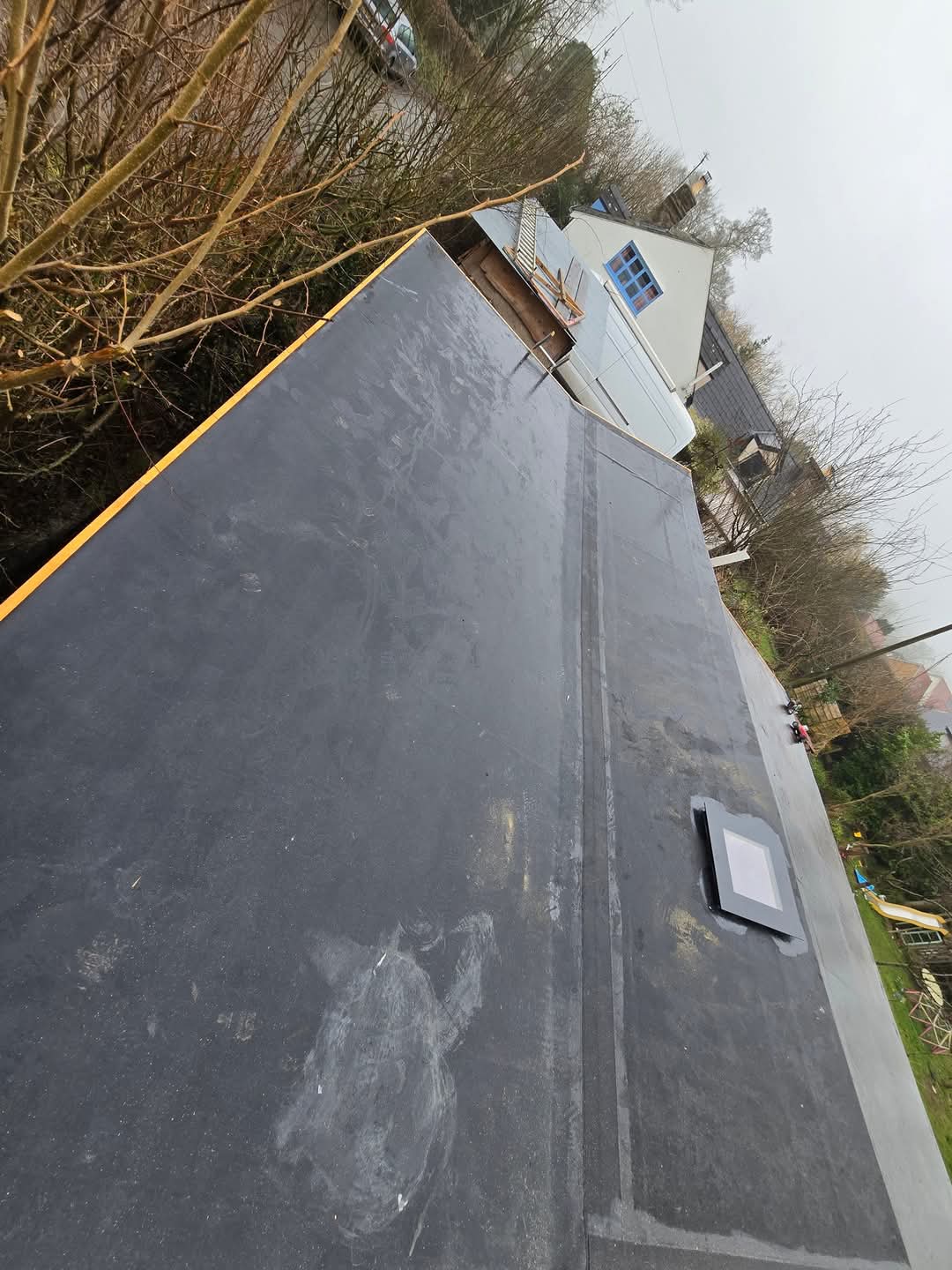 Finished EPDM roof with timber trims left bare for painting